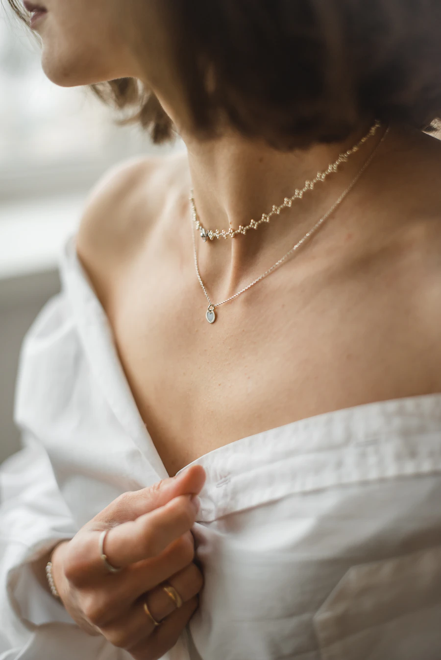 Close-up of a delicate gold necklace — protecting what is yours